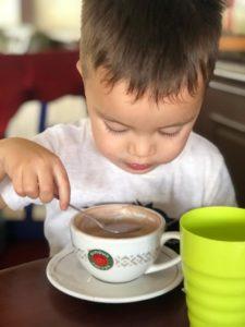 child having hot chocolate