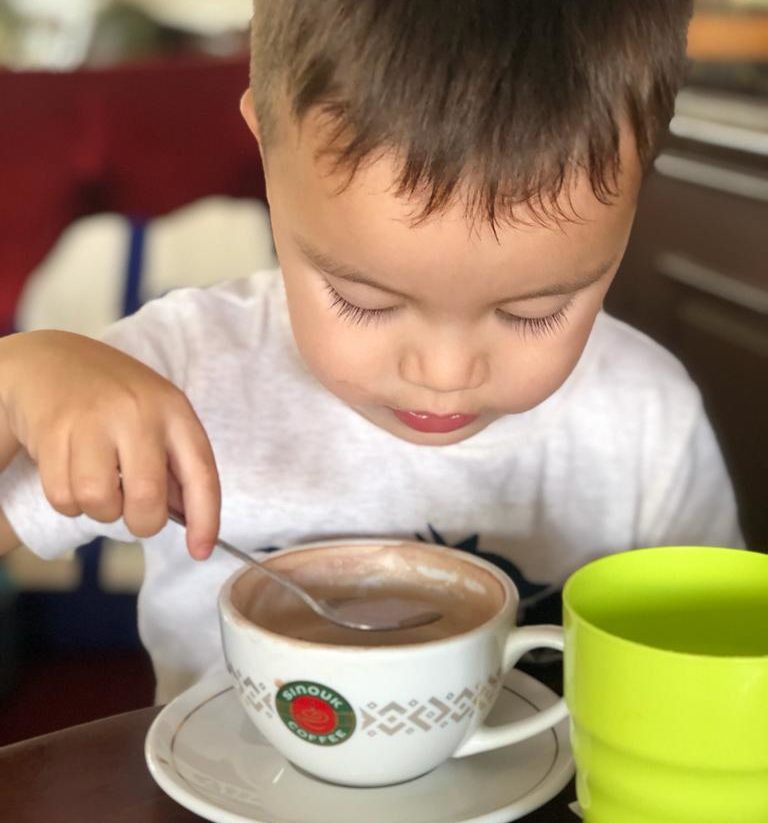 child having hot chocolate